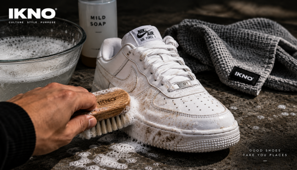 Cleaning white Air Force 1s with a soft-bristle brush