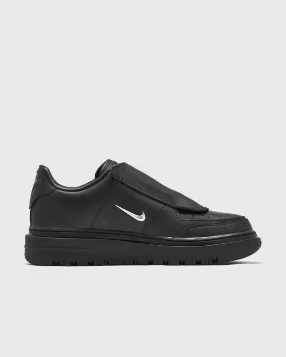 Inner side profile of black Nike Air Force 1 Luxe with metallic Swoosh