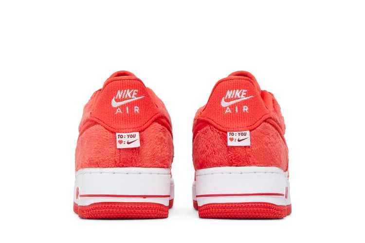 Rear view of the Nike Air Force 1 Low Valentine’s Day Fleece GS pair with red fleece and heart labels